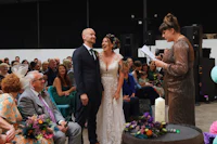 a bride and groom share their vows in front of an audience