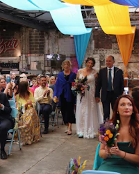 a bride and groom walking down the aisle