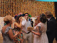 a group of people drinking at a wedding reception