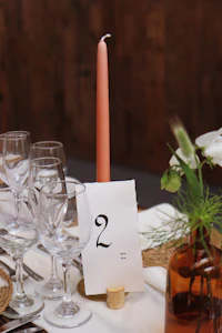 a table with a number of glasses and a candle