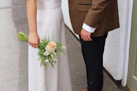 a bride and groom standing next to each other