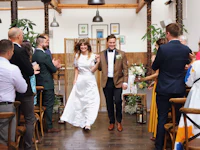 a bride and groom walking down the aisle at a wedding