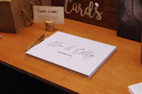 a wedding guest book sitting on a wooden table
