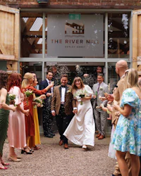 a group of brides and grooms standing outside of a building