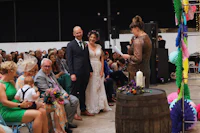 a bride and groom standing in front of a crowd of people
