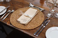 a place setting on a table with silverware and a napkin