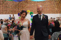 a bride and groom walking down the aisle at a wedding