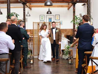 a bride and groom walking down the aisle at a wedding