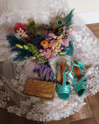 a bouquet of flowers and a pair of blue shoes