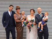 a group of people posing with a baby