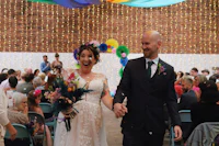 a bride and groom walking down the aisle at a wedding
