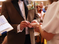 a bride and groom exchanging their wedding rings
